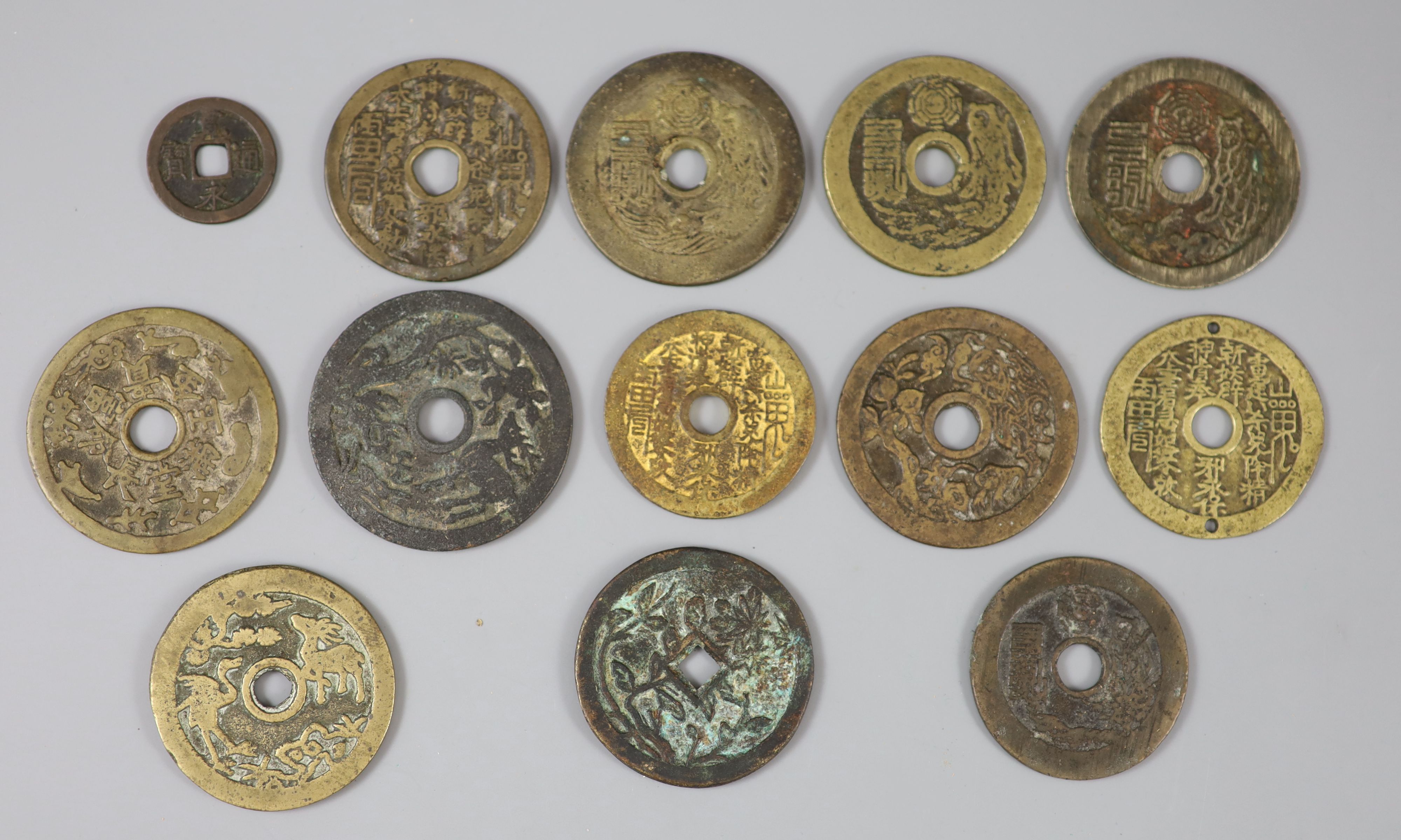 China, 12 cast bronze charms or amulets, Qing dynasty,